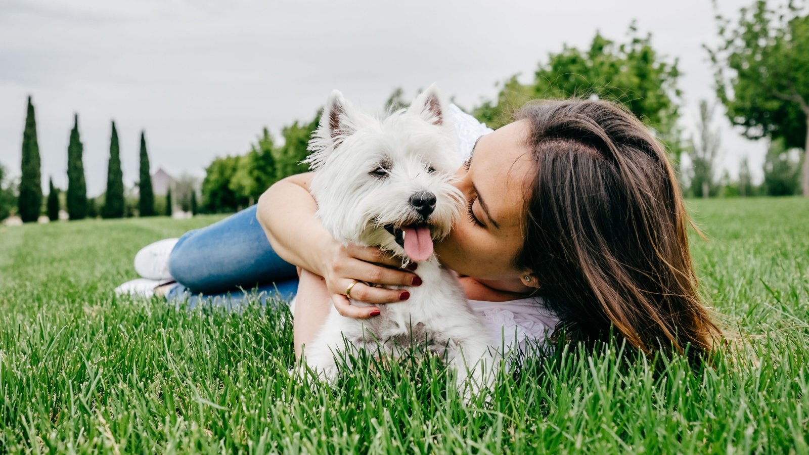 Woman With West Highland White Terrier Dog Outside Lucia Romero Shutterstock