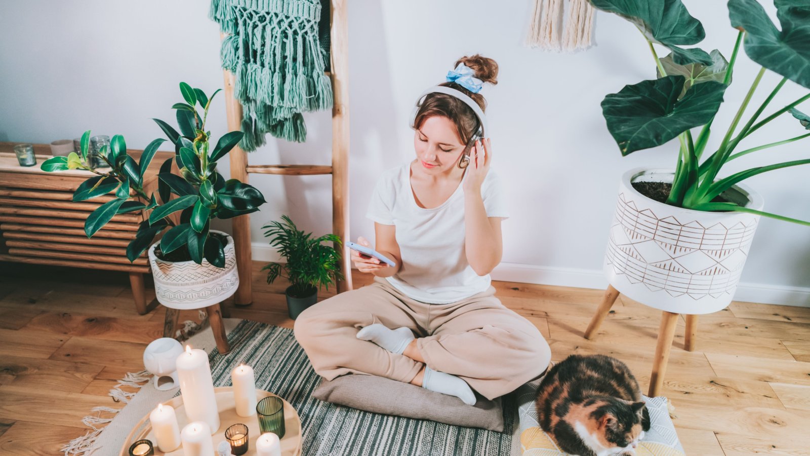 Woman Young Cat Meditation Healthy Candle cozy Okrasiuk Shutterstock