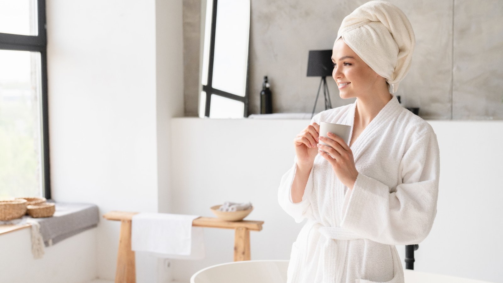 Woman bathing robe self care tea coffee relax spa Inside Creative House Shutterstock