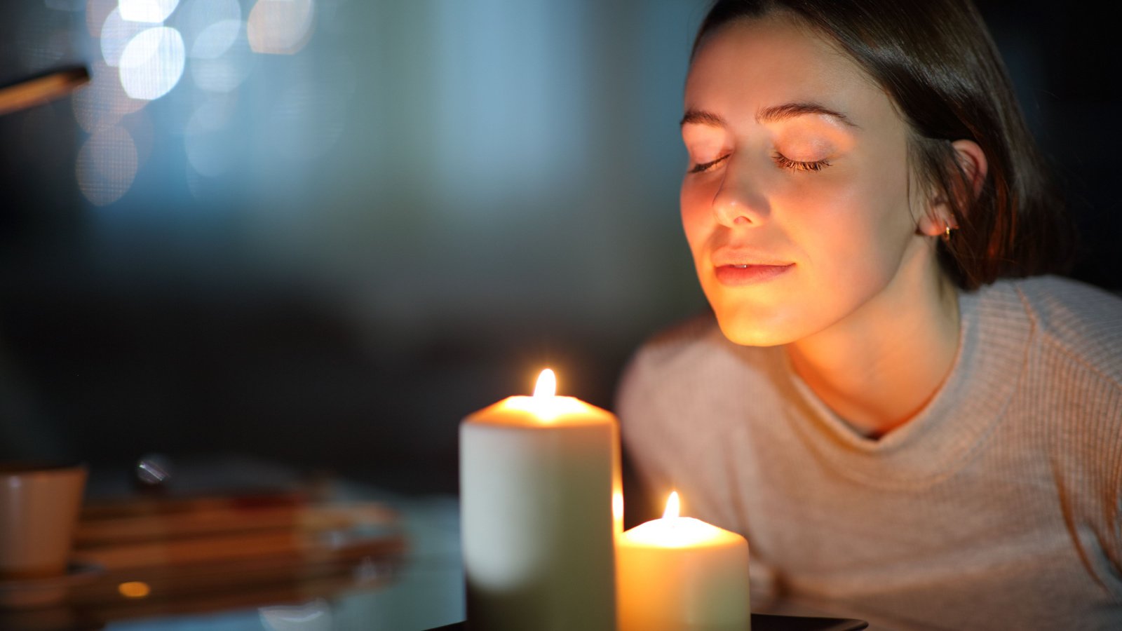 Woman candle scent relax home stress Antonio Guillem Shutterstock