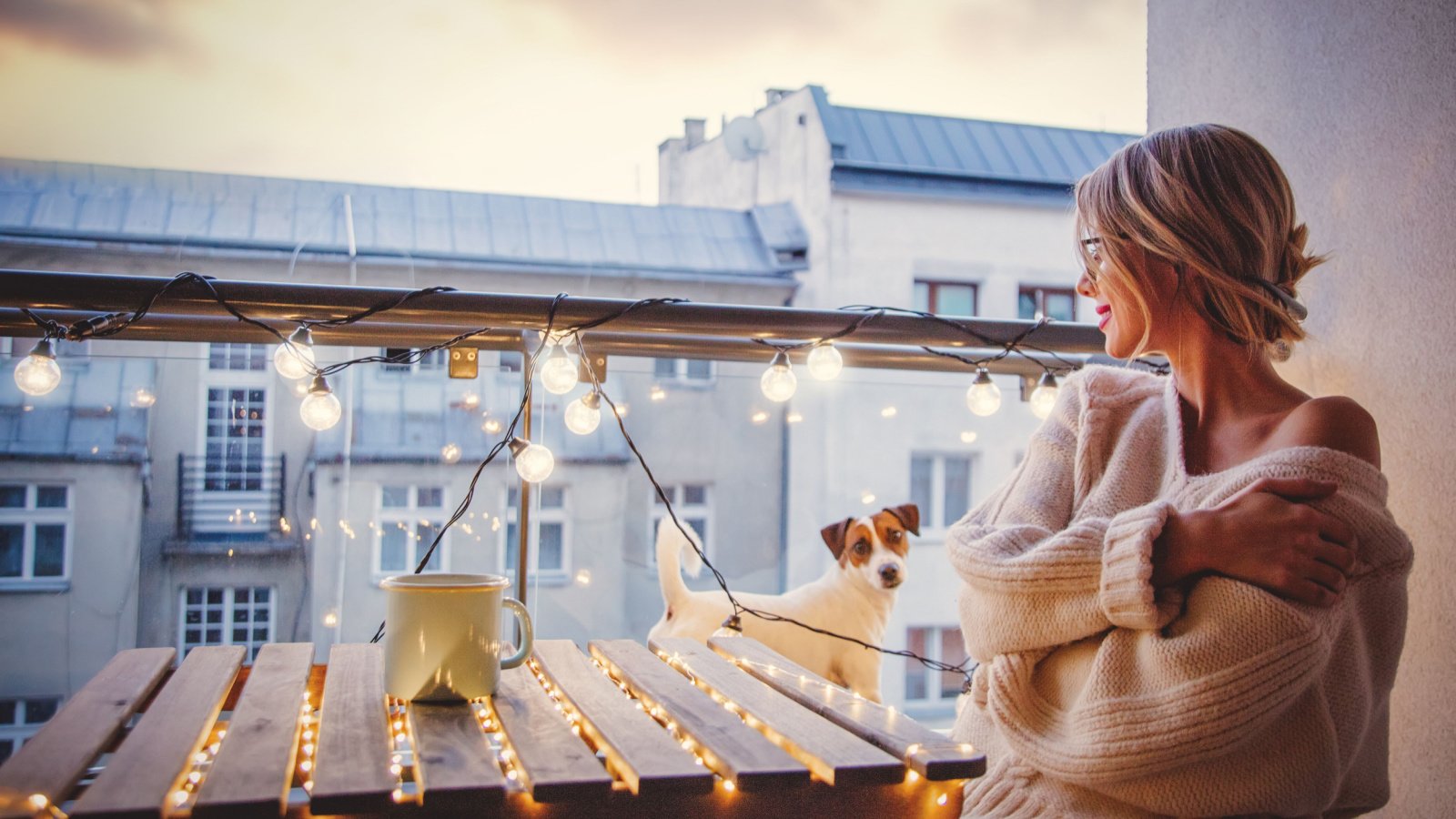 Woman coffee dog ambient lighting urban balcony relax Masson Shutterstock