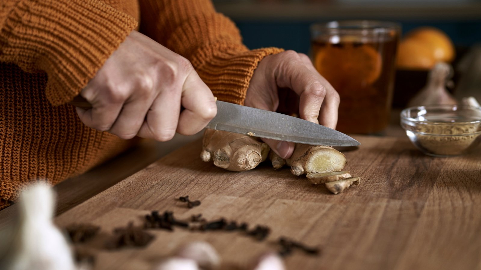 Woman cutting ginger spice root gpointstudio Shutterstock