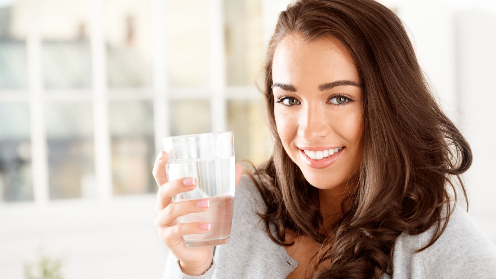 Woman drinking water hydration health Aila Images Shutterstock