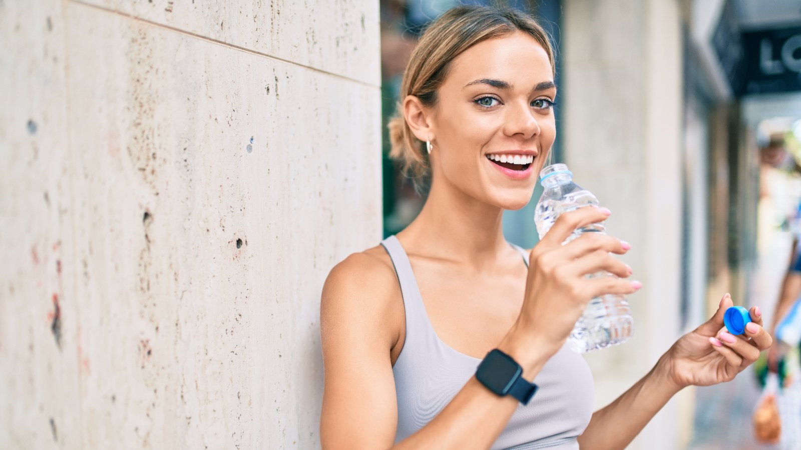 Woman drinking water plastic bottle hydration fitness exercise Krakenimages.com Shutterstock