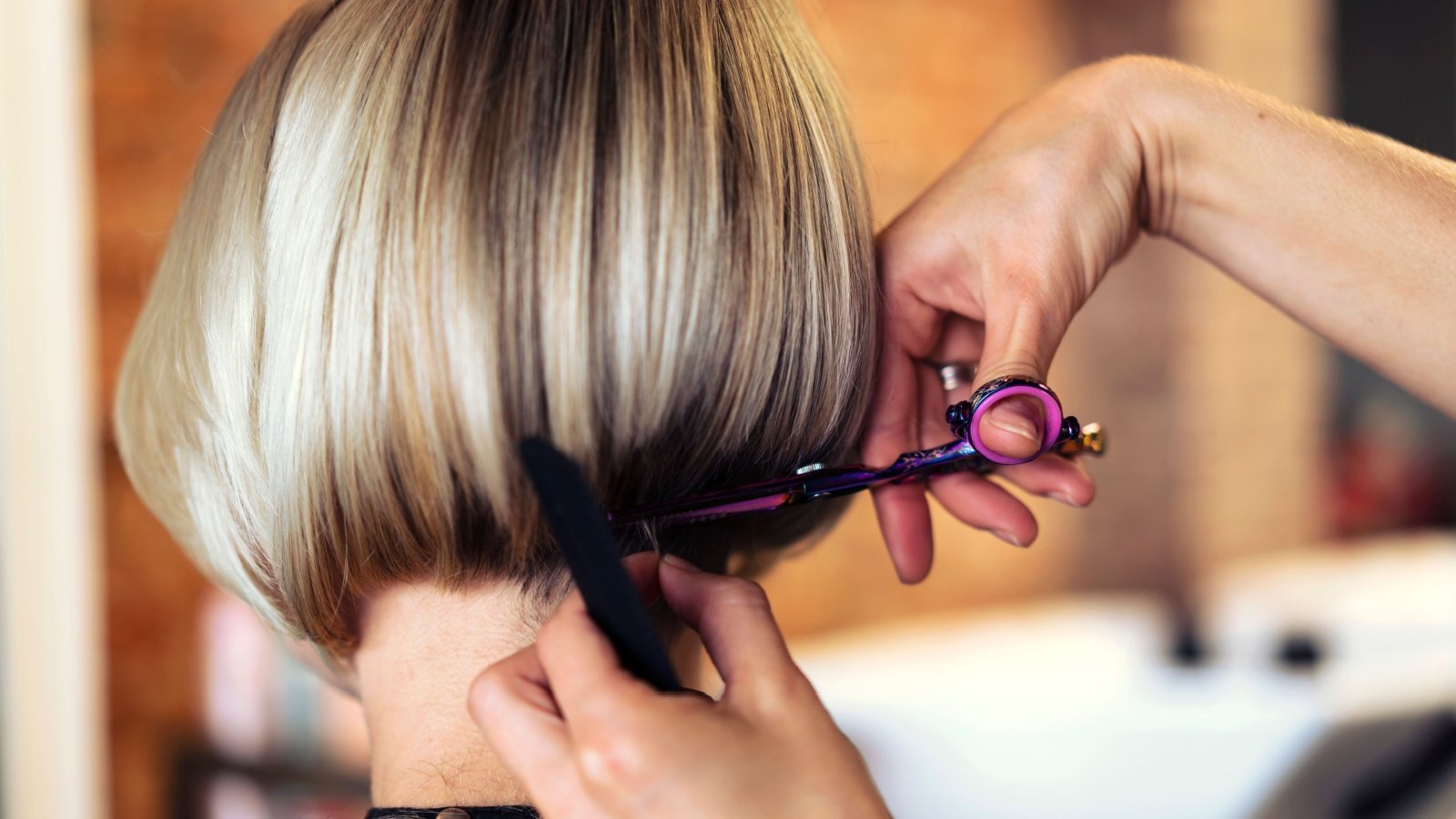 Woman getting a bob haircut in a salon scissors beauty Alexandra Kalashnikova Shutterstock