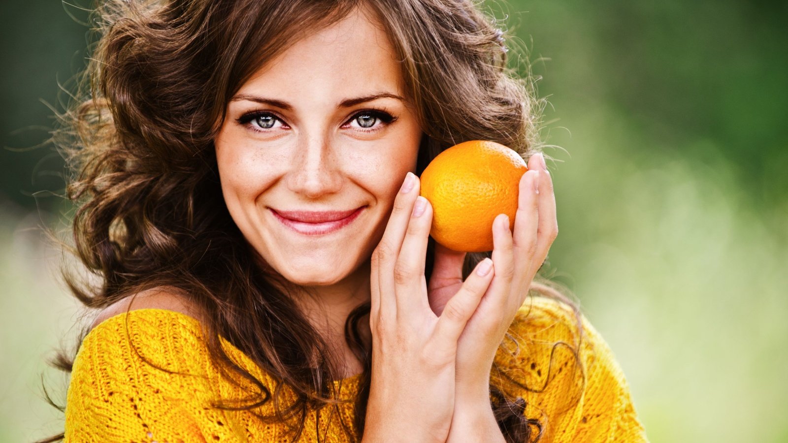 Woman holding an orange fruit eat BestPhotoStudio Shutterstock