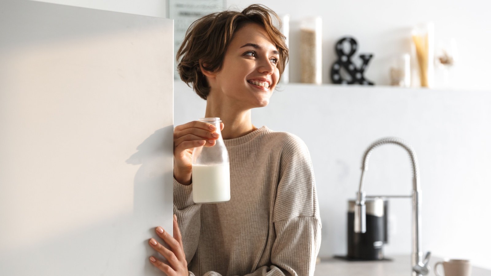 Woman in Kitchen Fridge Milk Dean Drobot Shutterstock