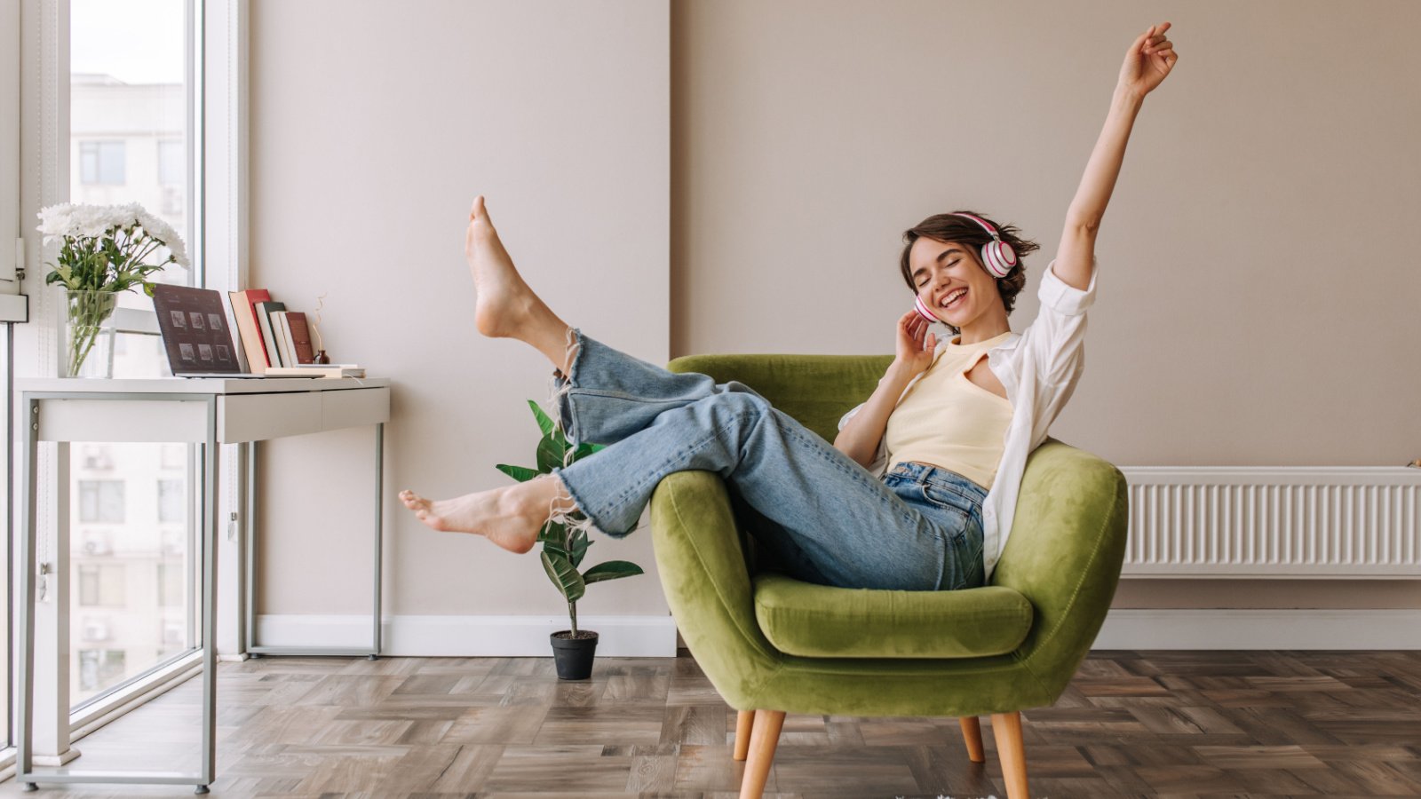 Woman listening music headphones chair decor Look Studio Shutterstock