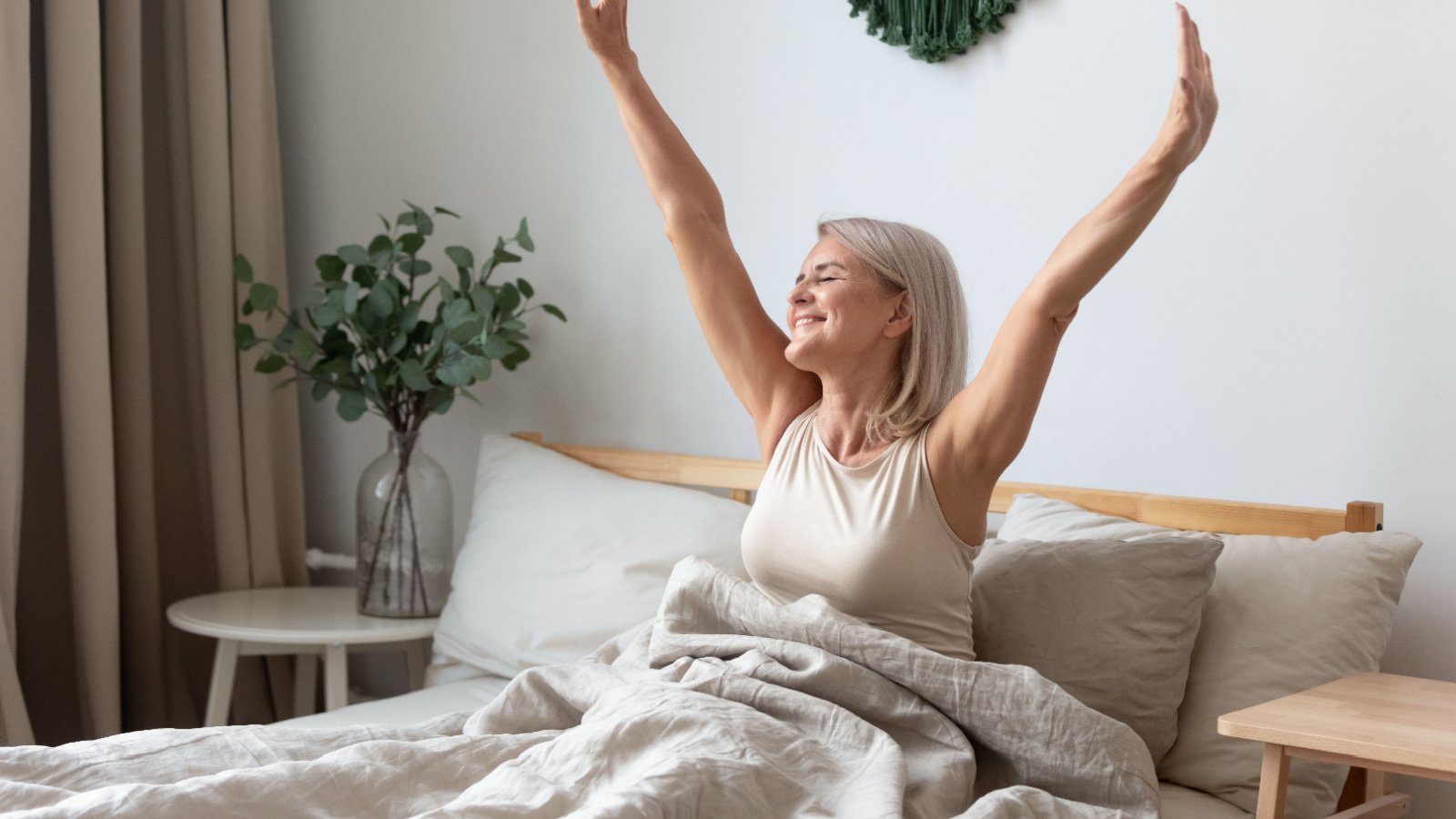 Woman mature awake rested health sleep bed fizkes Shutterstock