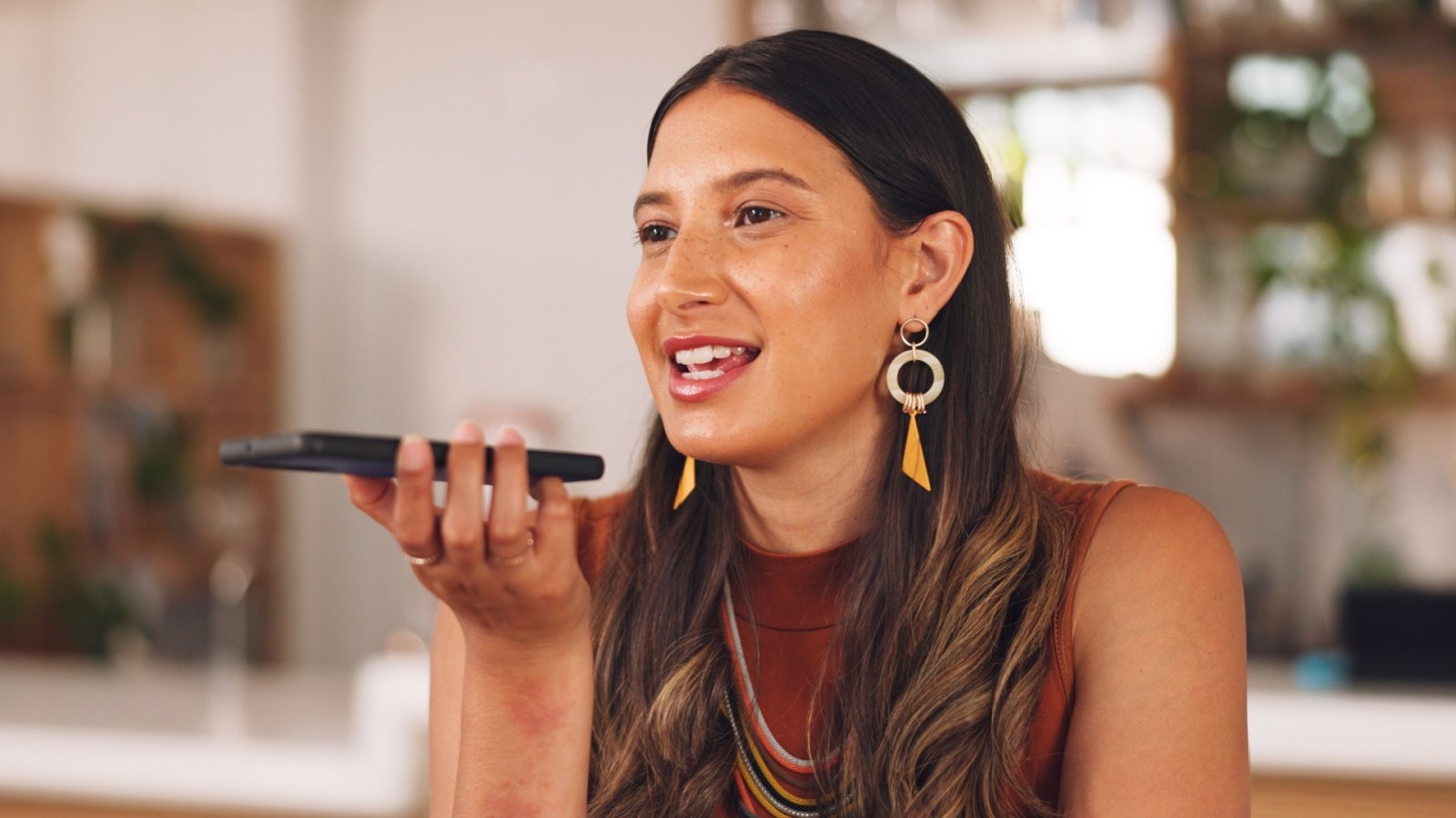 Woman talking on speaker phone voice memo record PeopleImagescom Yuri A Shutterstock