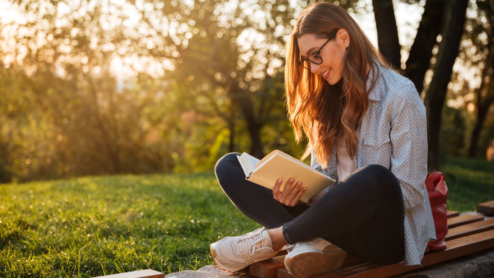 Woman young reading outside hobby Dean Drobot Shutterstock