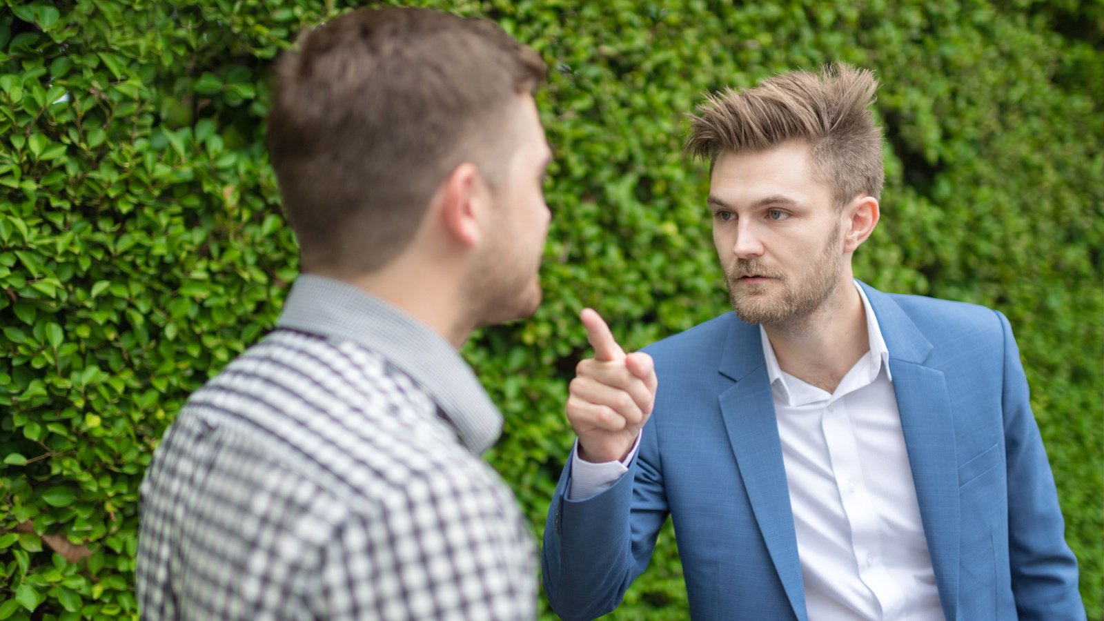 Young bearded business man pointing a finger to partner and blaming men brothers suits fight little pig studio shutterstock