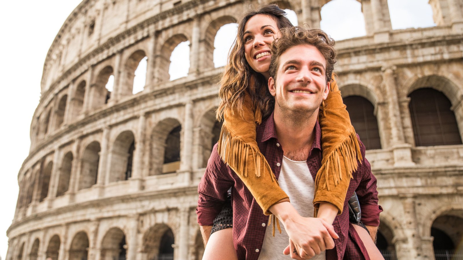 Young couple at the Colosseum Rome travel trip oneinchpunch shutterstock