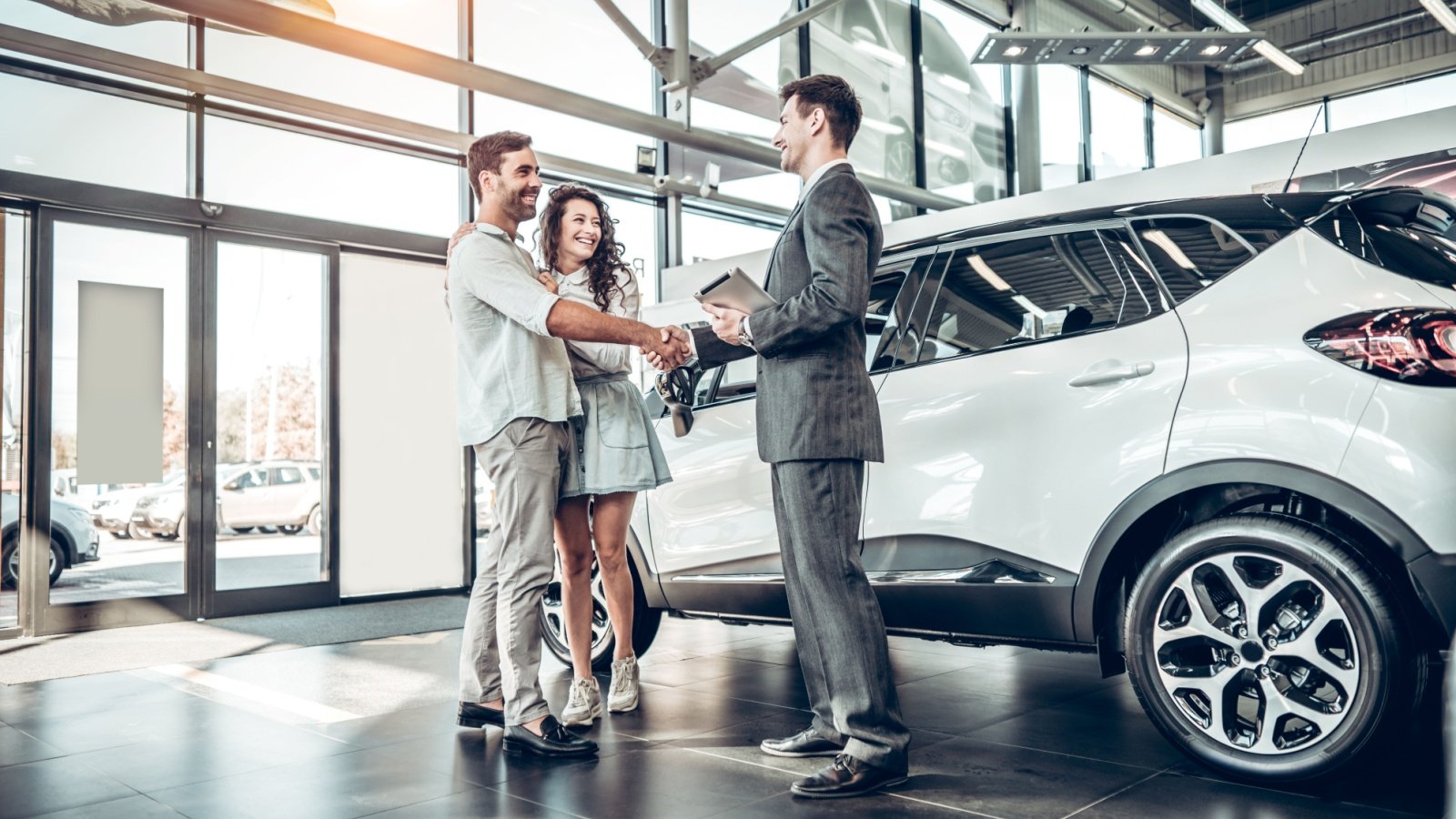 Young couple car dealership buying Harbucks Shutterstock