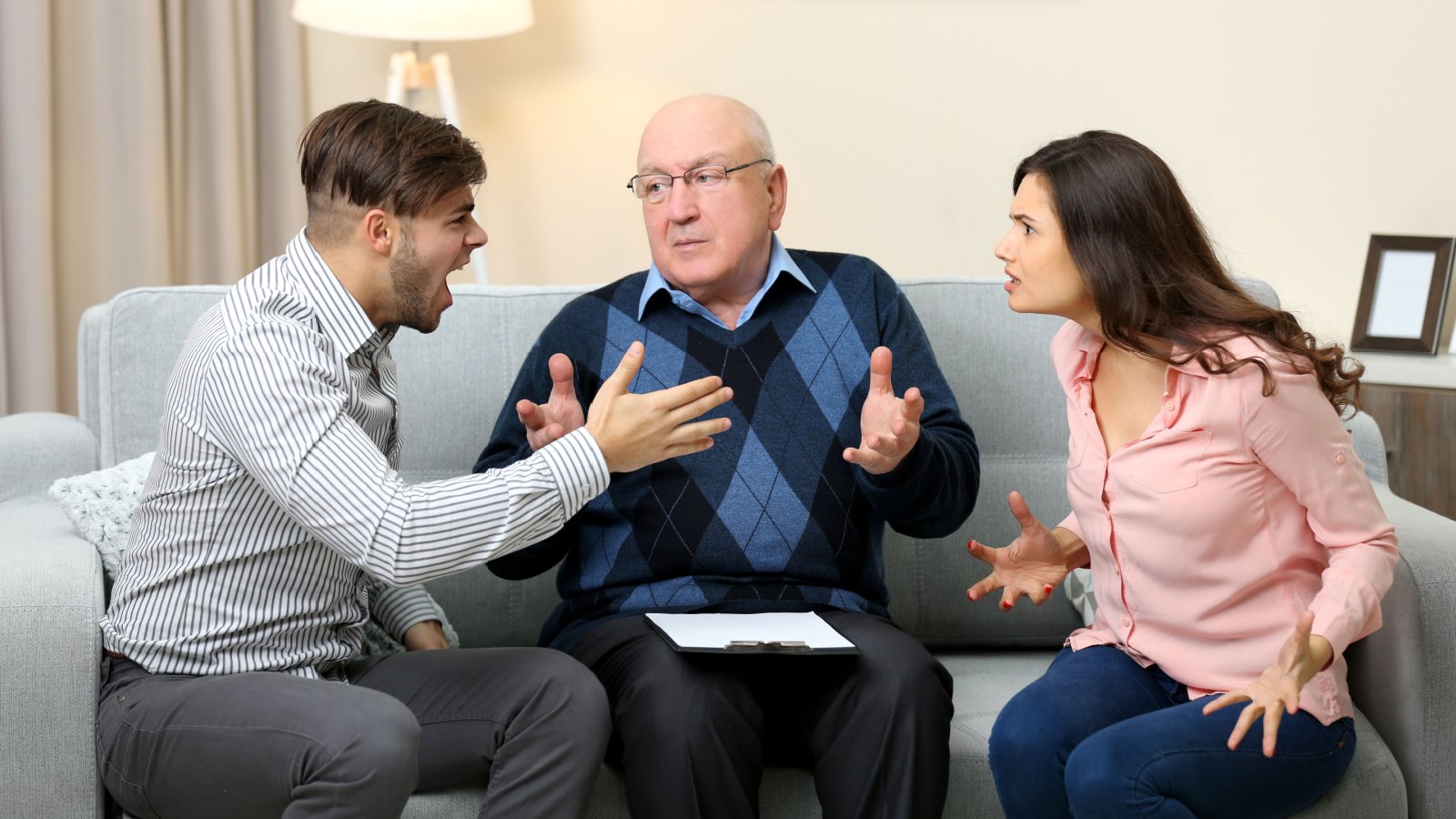 Young couple with problem on reception for family father fight Psychotherapy africa studio shutterstock