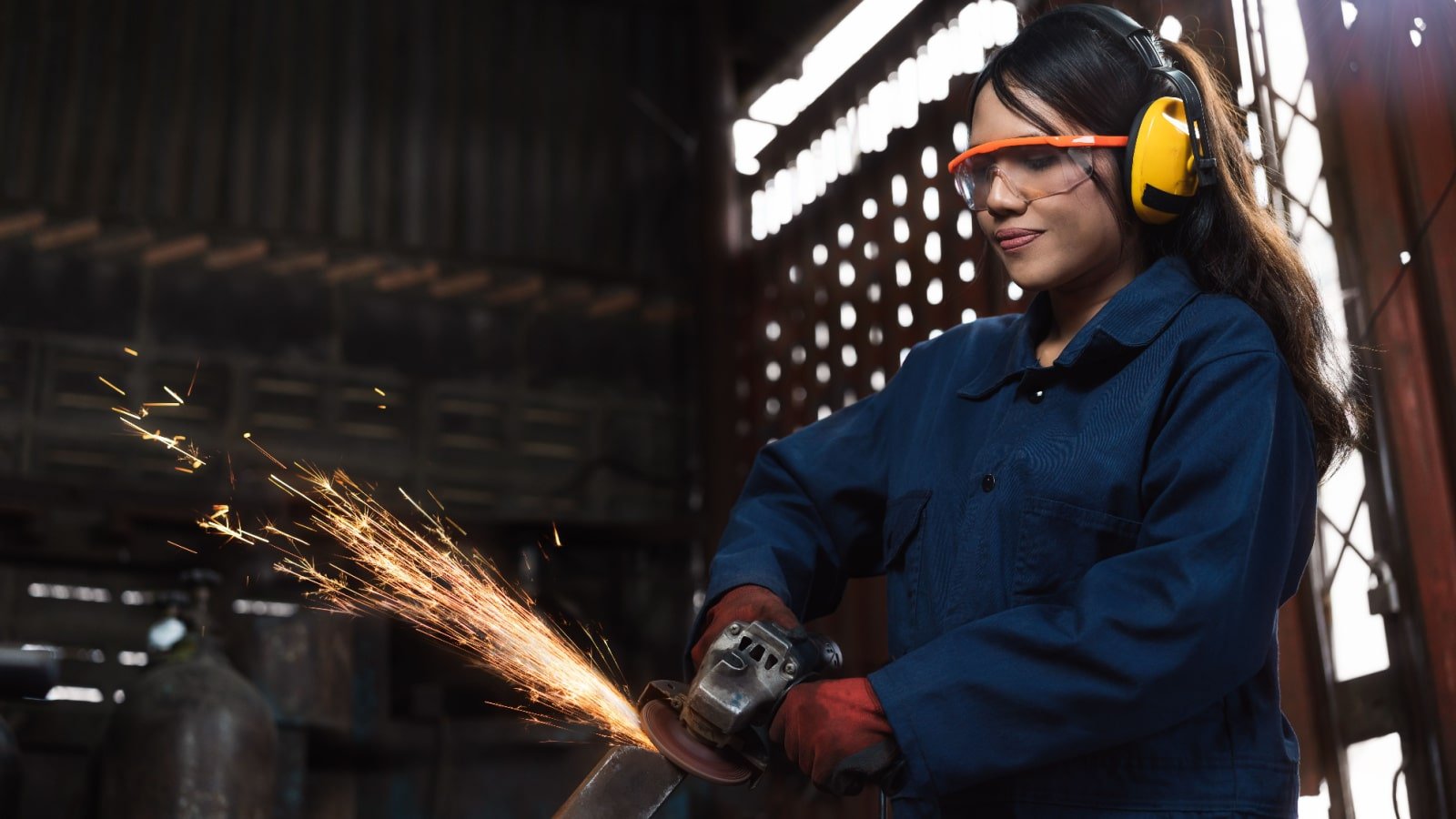 Young female engineer operating power tools apprentice workshop Dubo Shutterstock