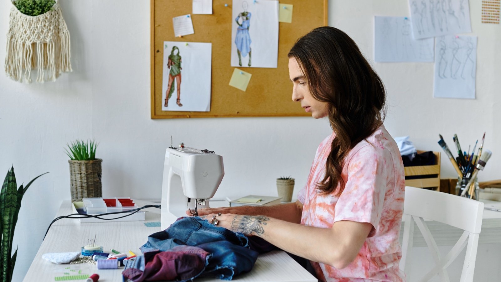 Young man sewing clothing entrepreneur LightField Studios Shutterstock