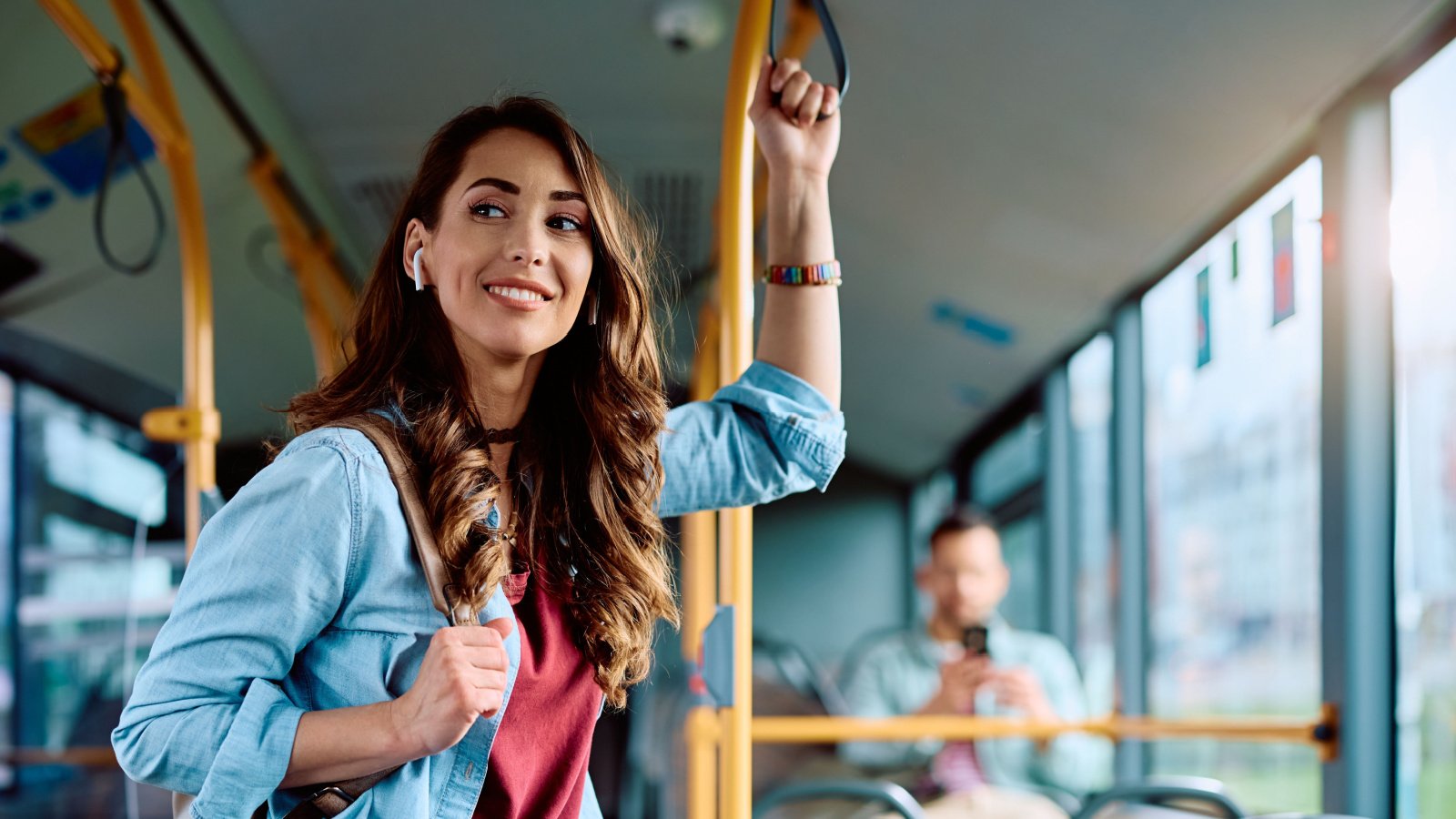 Young smiling woman traveling public bus city Drazen Zigic Shutterstock