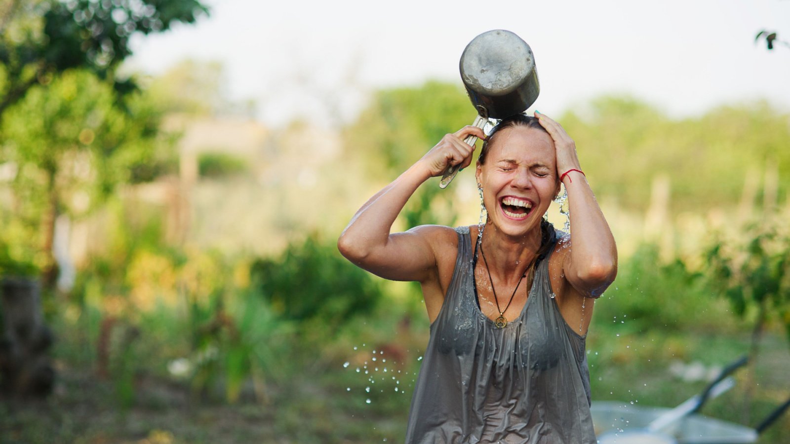 Young woman pours water and fun in summer. Fun summer holidays. Pouring cold water. Ice bucket challenge unguryanu shutterstock