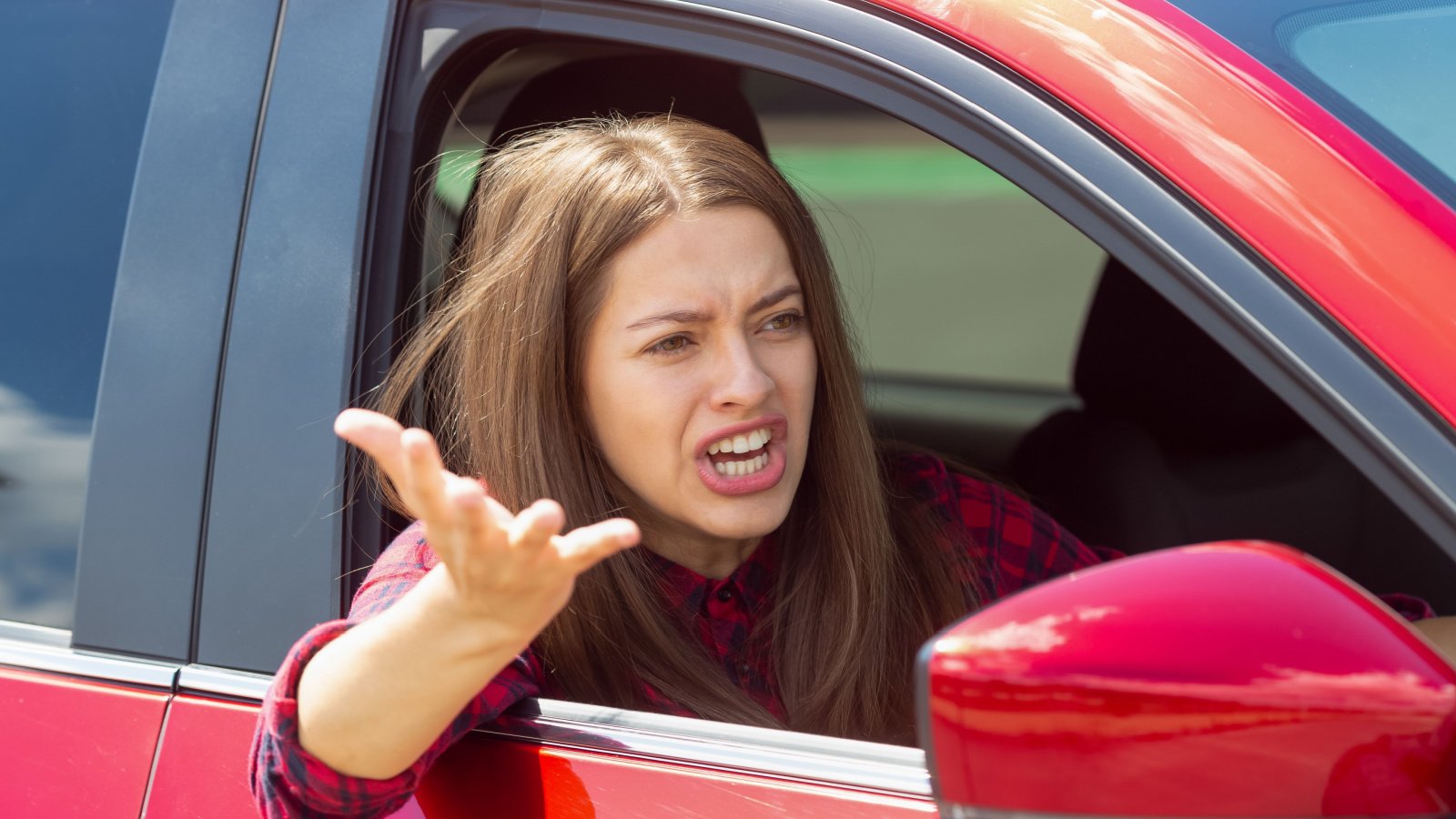 angry woman in car driving yelling