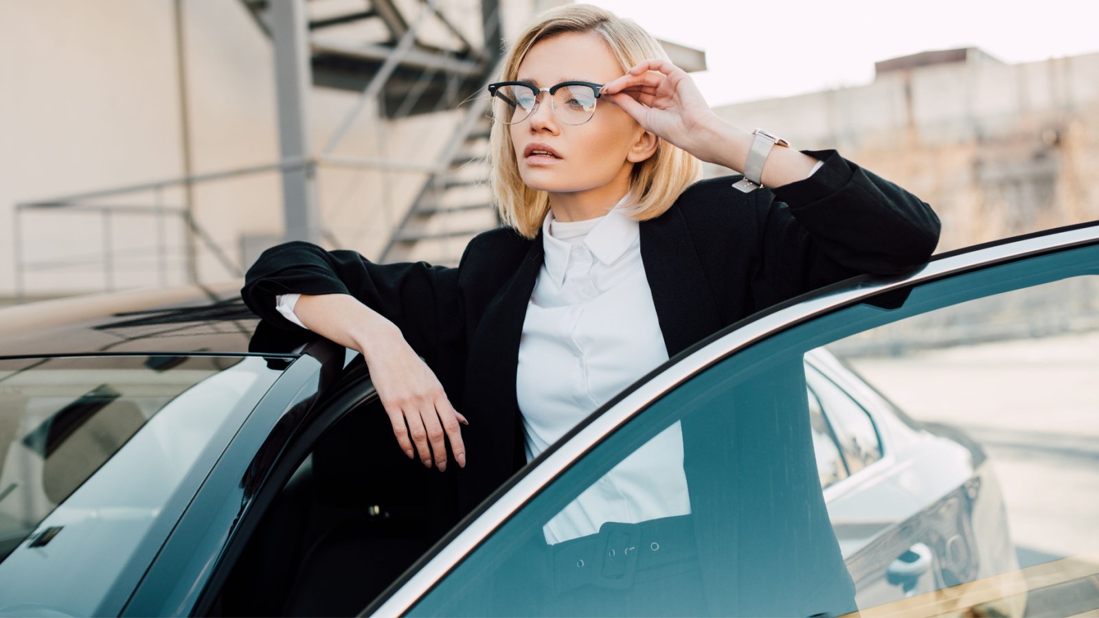 blonde young woman in glasses car and glasses driving parking lightfield studios shutterstock