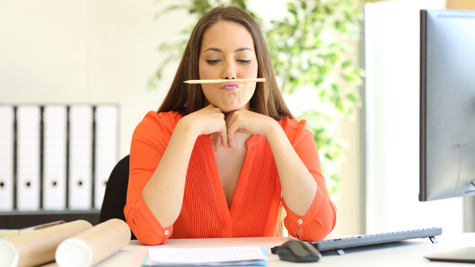 bored woman at work wasting time Antonio Guillem shutterstock