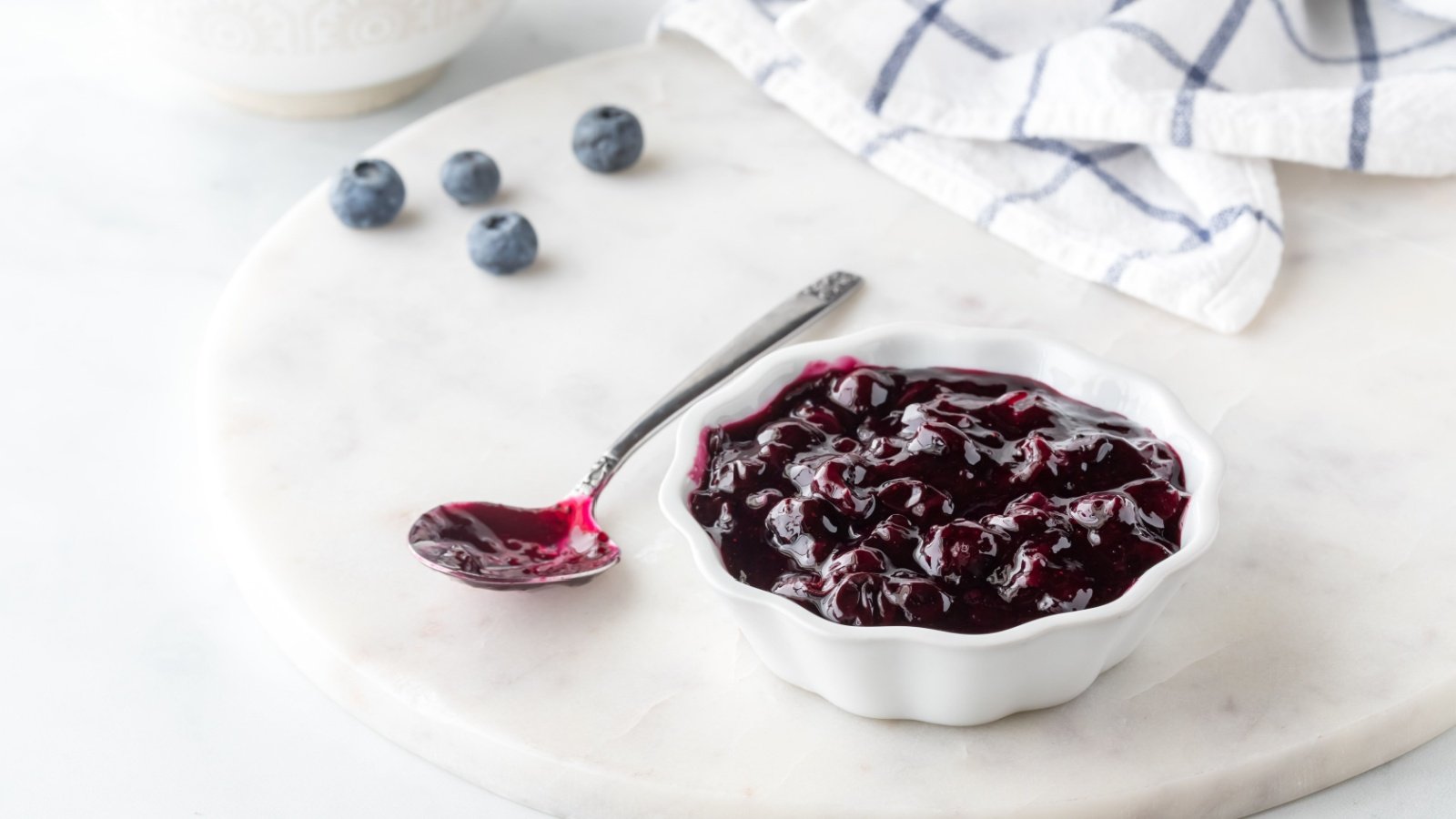 bowl of sweet homemade blueberry sauce on a marble slab Wojapi Carey Jaman Shutterstock