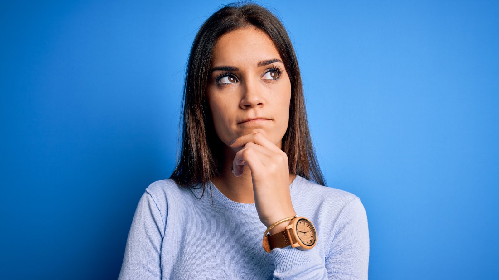 brunette woman wearing casual sweater pensive question thinking idea kraken images shutterstock