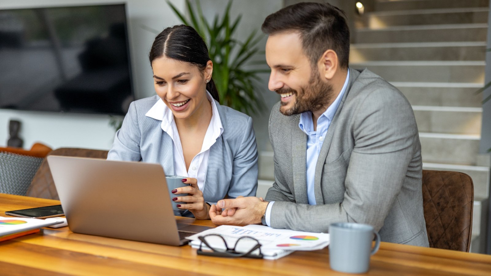 business people using laptop and discussing about new project at office work investing ivanko80 shutterstock