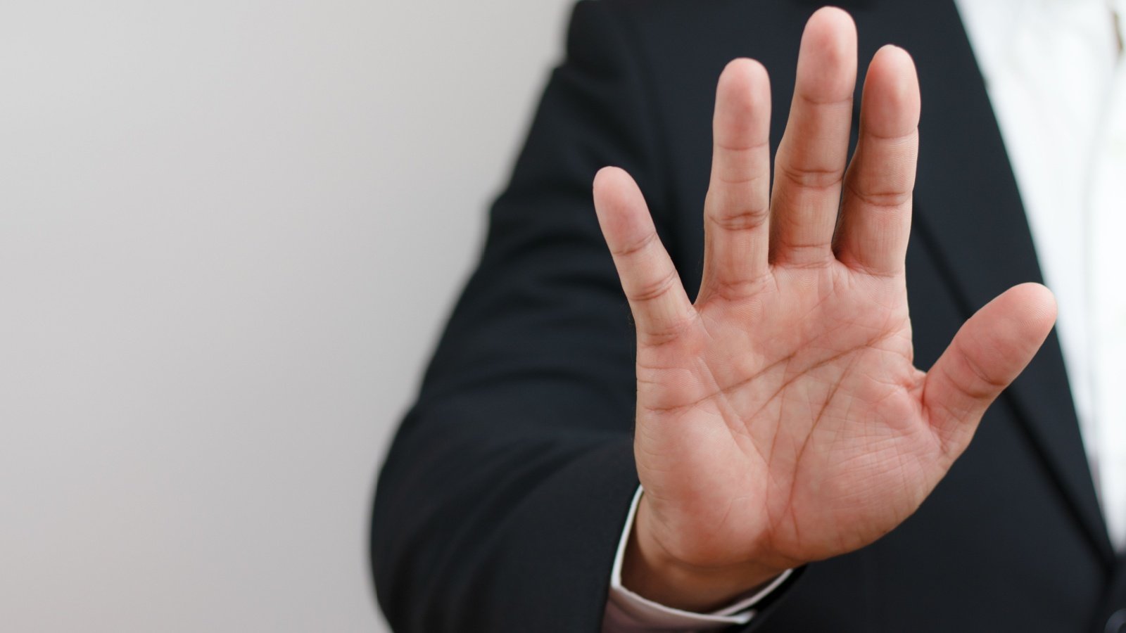 businessman raising his hand to stop forbid invalid Corruption illegal no refuse NAN2535 Shutterstock