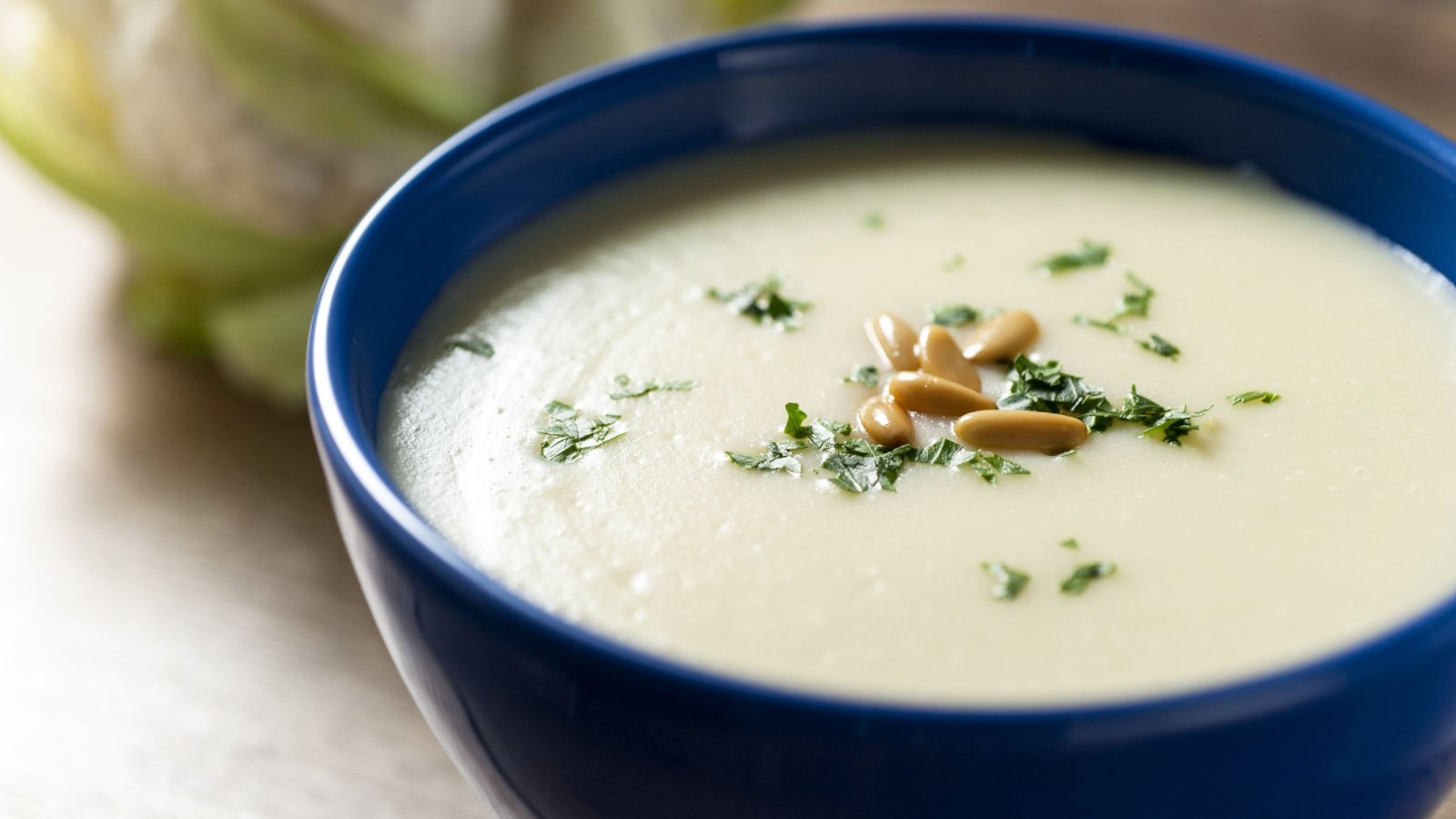 cauliflower potato cream with parsley and pine nuts soup bowl PiraPora Shutterstock