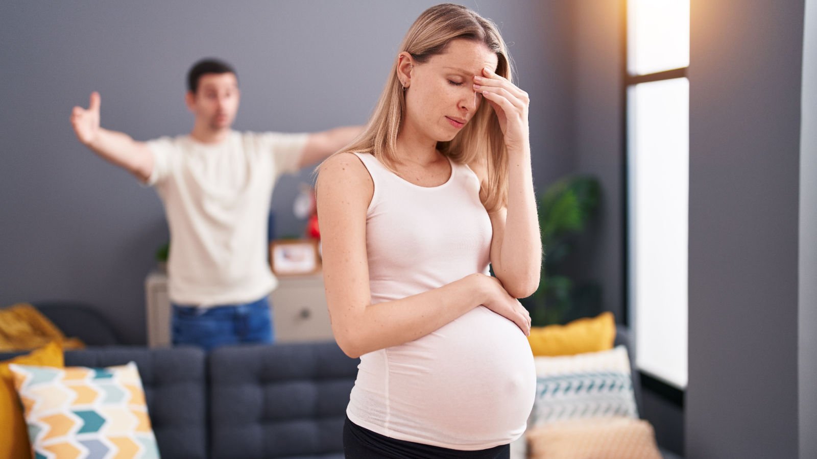 couple expecting baby arguing at home pregnant fight kraken images shutterstock