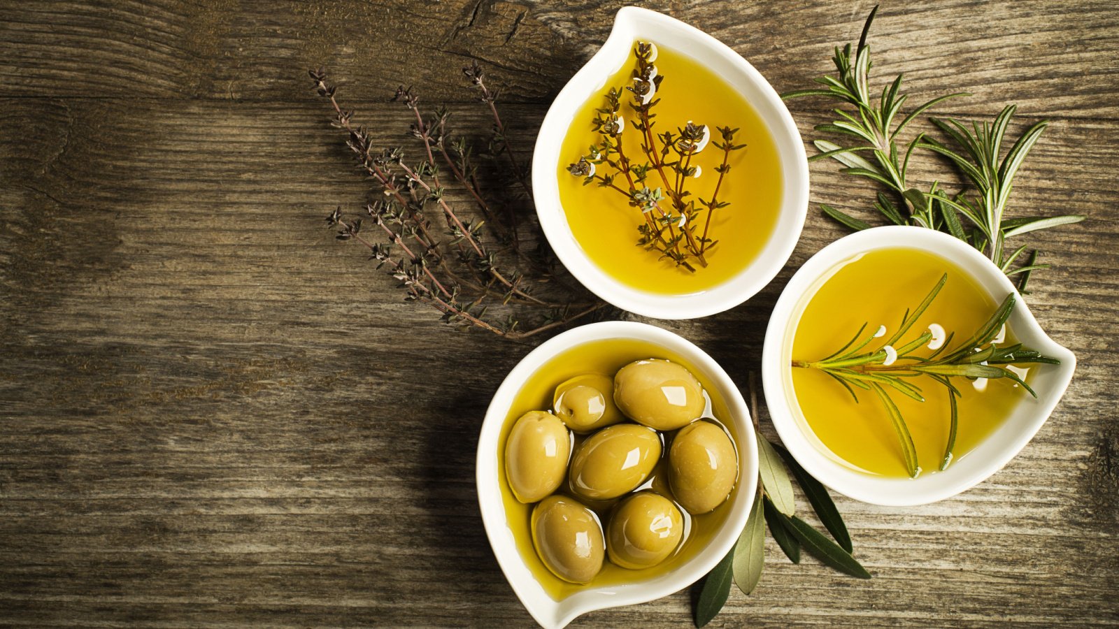 foods Olive oil with fresh herbs and olives DUSAN ZIDAR Shutterstock