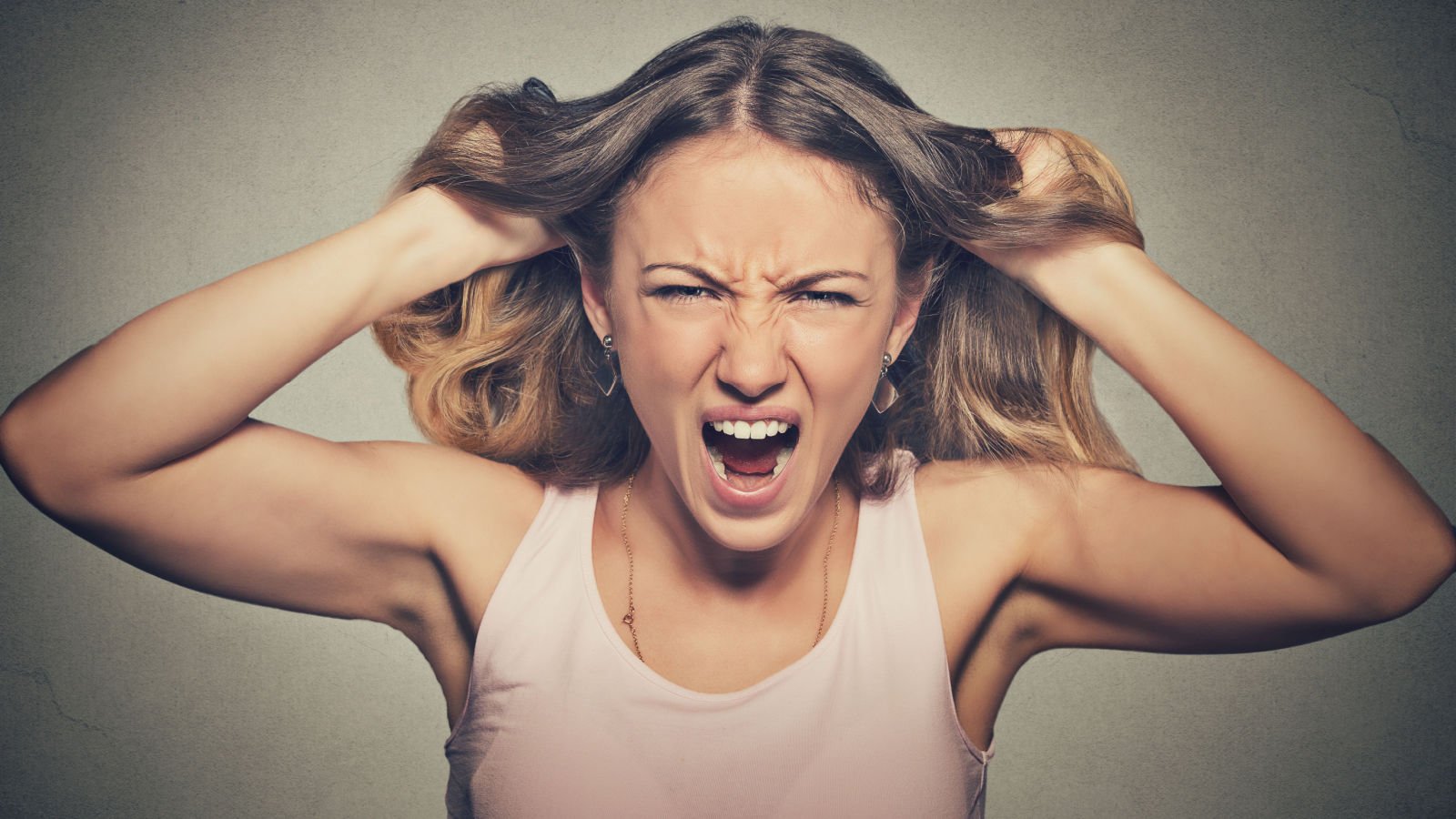 frustrated angry woman pulling hair out yelling screaming temper pathdoc shutterstock