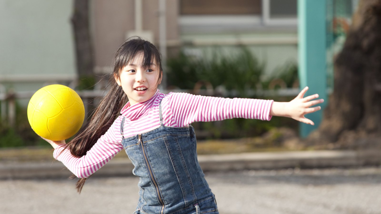 girl playing dodge ball playground KPG Payless Shutterstock