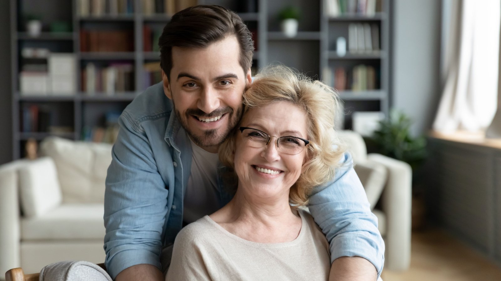 happy adult son with senior mother below