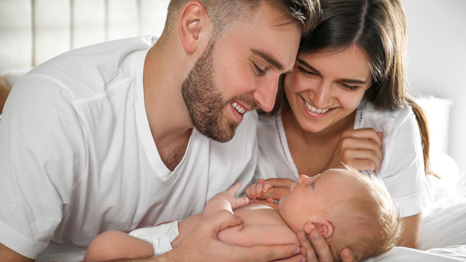 happy couple with their newborn baby new africa shutterstock