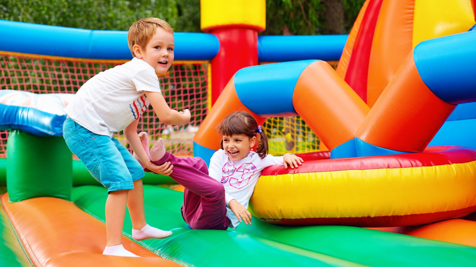 happy kids having fun on inflatable attraction playground olesia bilkei shutterstock