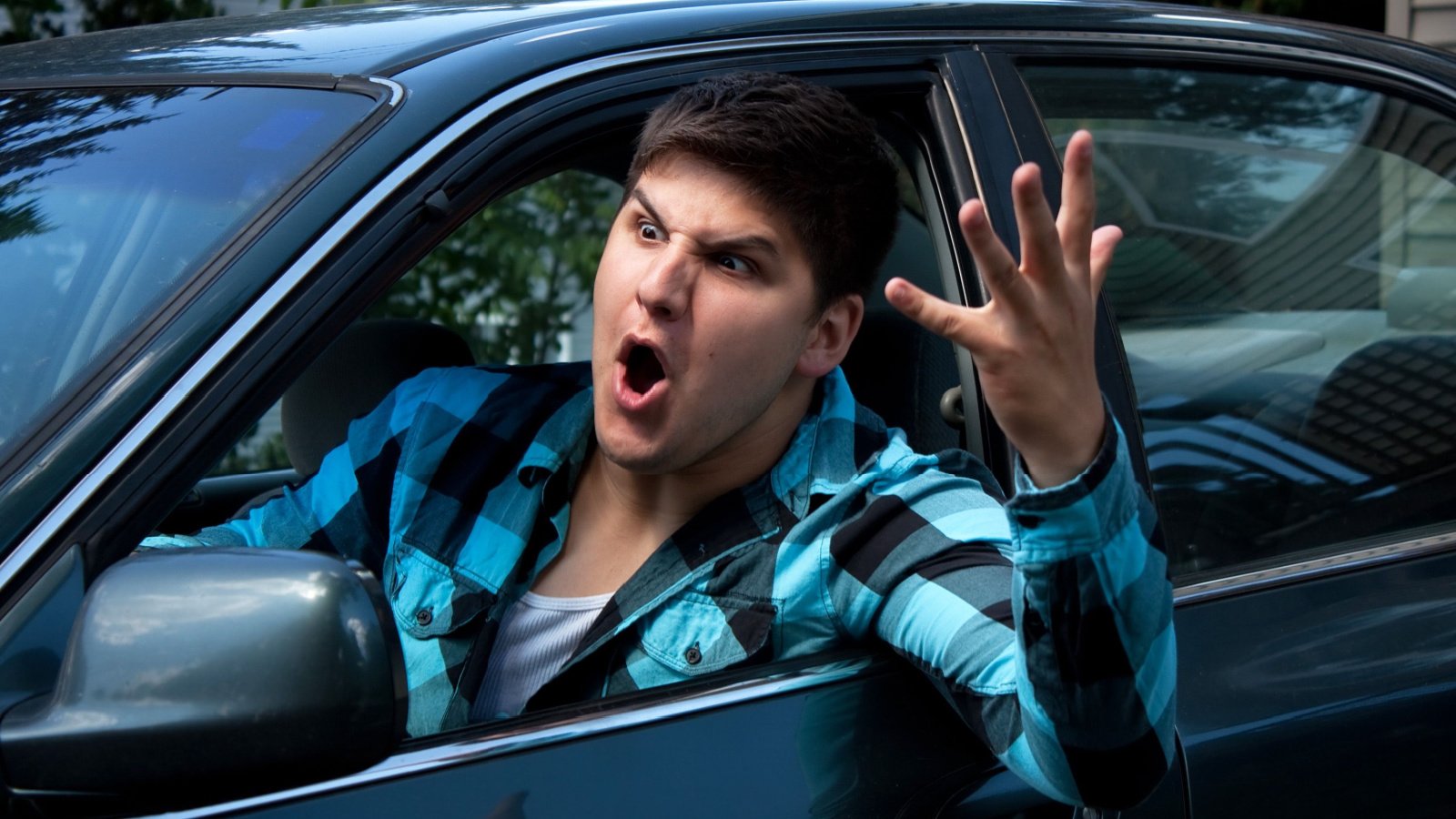 irritated young male driving a vehicle is expressing his road rage car driving parking arena creative shutterstock