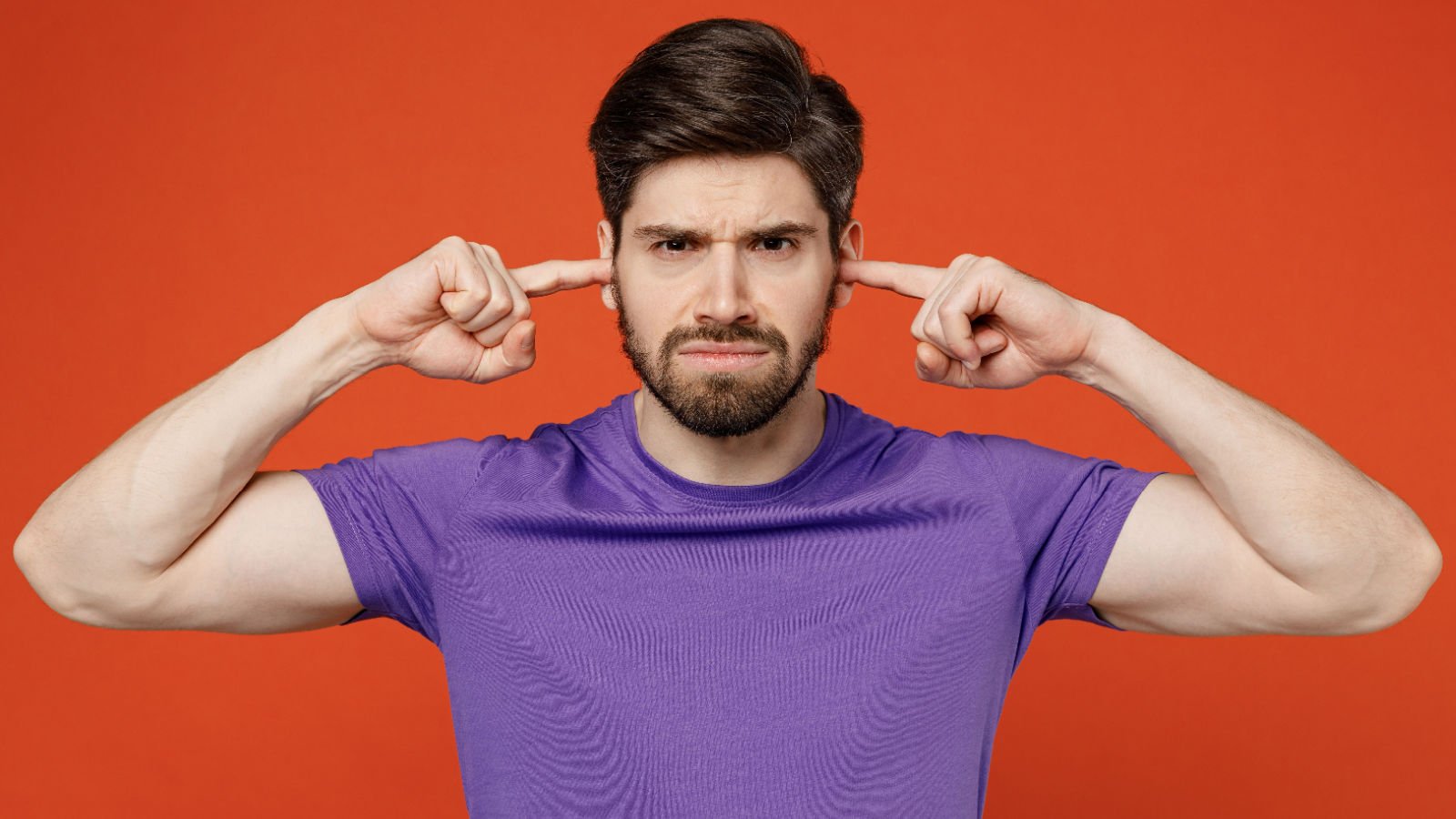 male fingers in ears listening vidl studio shutterstock