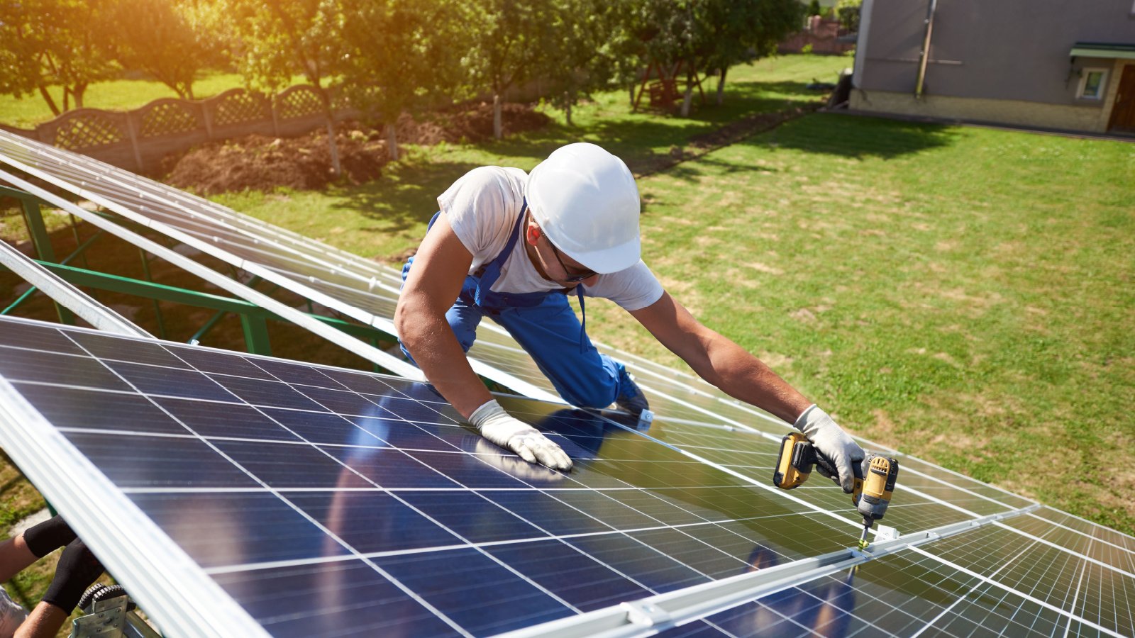 man jobs installing solar pannels on roof anatoliy gleb shutterstock