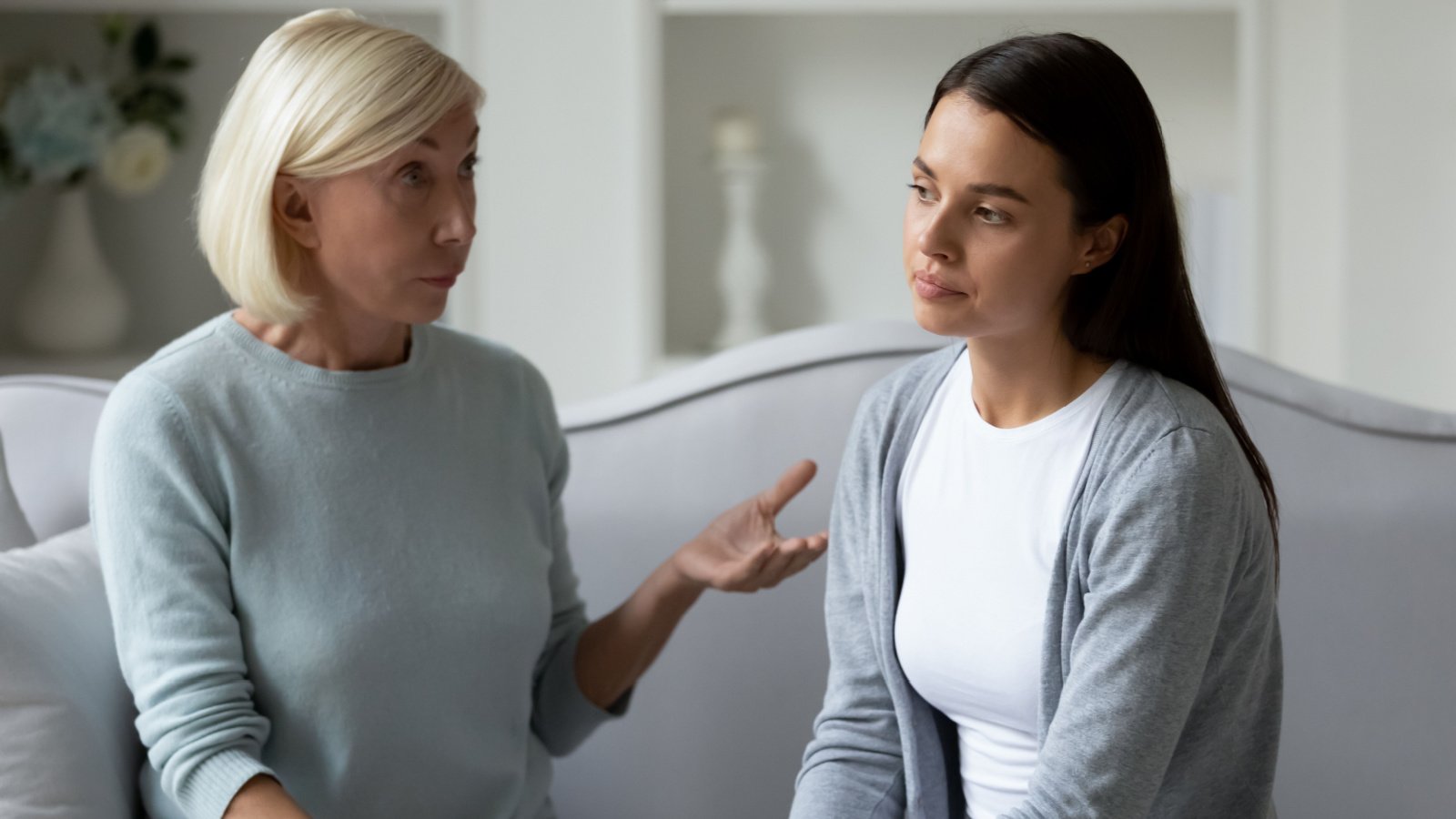 middle age mother talking to stressed young daughter fizkes shutterstock