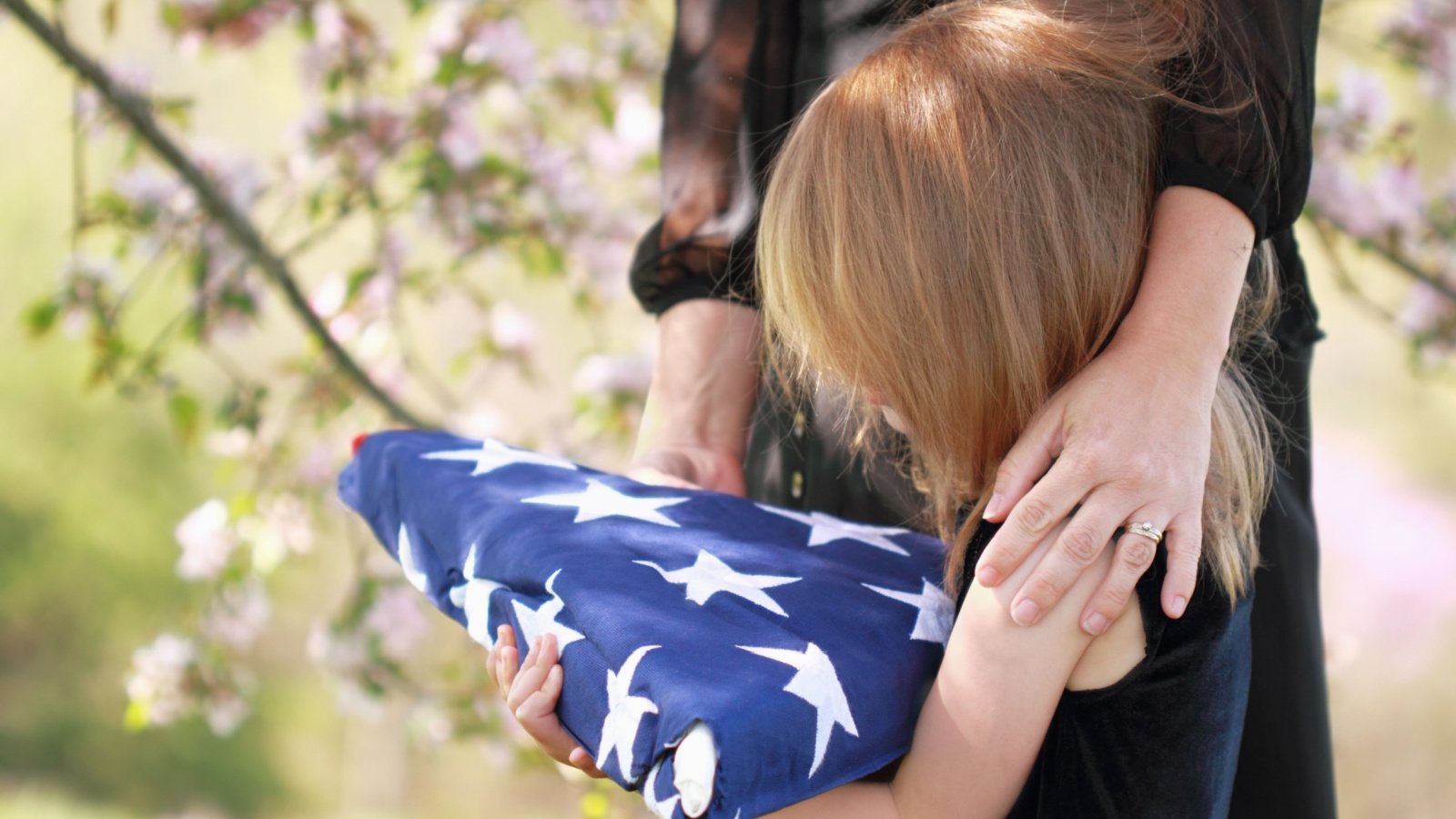 military funeral daughter holding us flag Stephanie Frey shutterstock