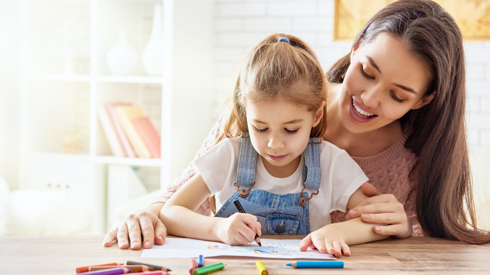 mother and daughter painting and drawing together teaching