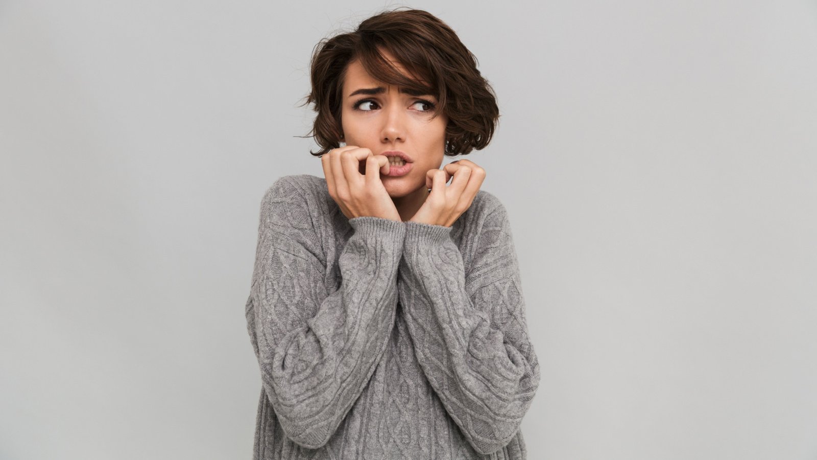 nervous young woman dressed in sweater scared dean drobot shutterstock