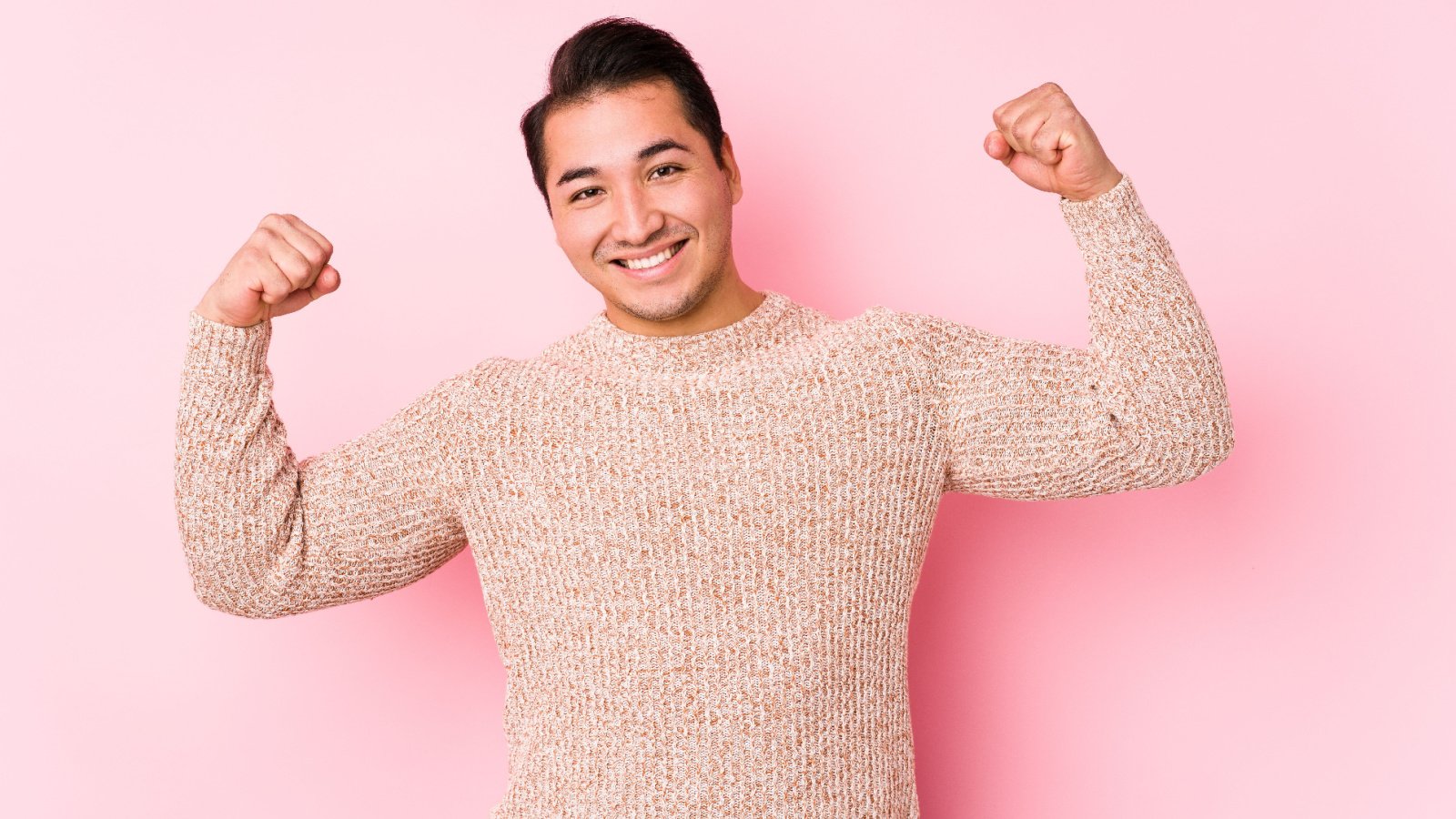 plus size male posing in a pink background isolated showing strength asier romero shutterstock