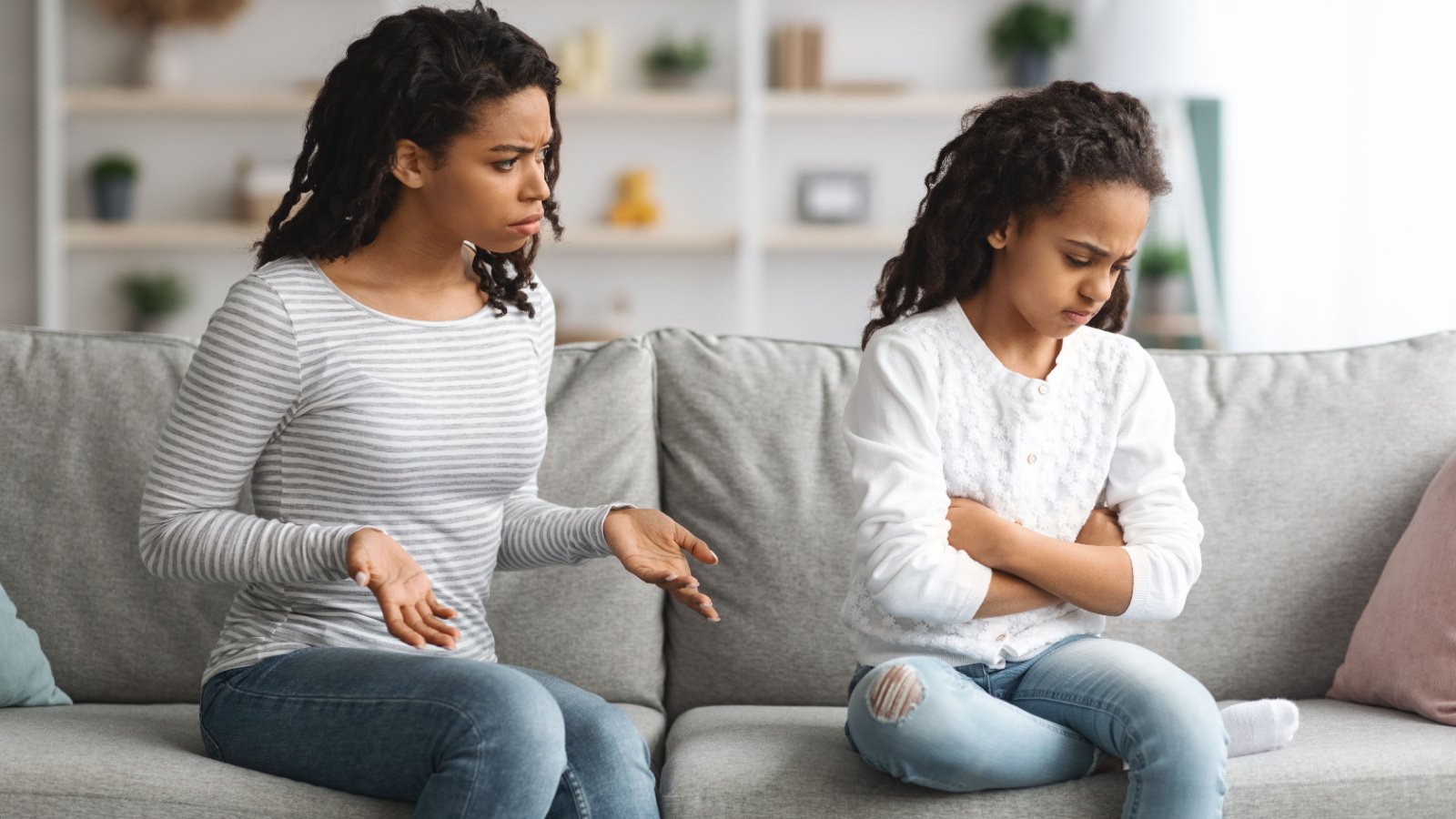 poc mother daughter fight argument at home on couch