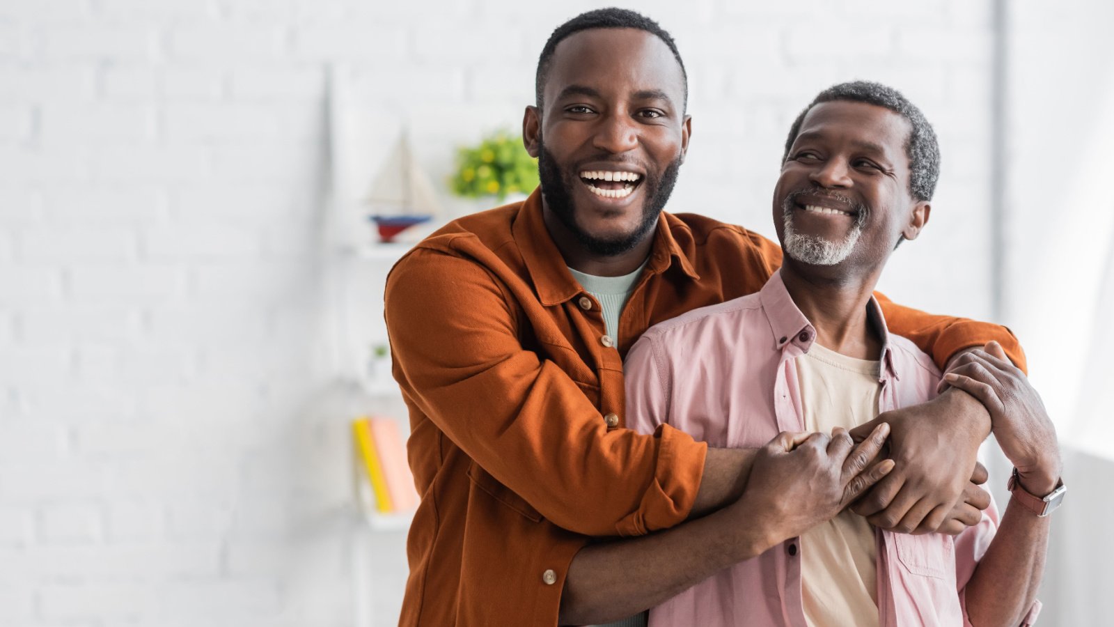 poc older father senior son hugging happy