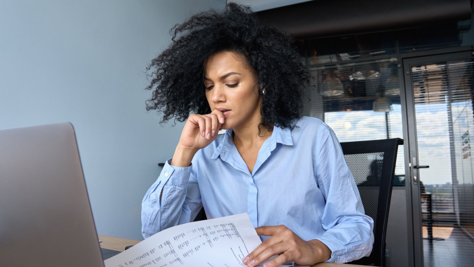 poc woman financial advisor tax concerned reading papers ground picture shutterstock