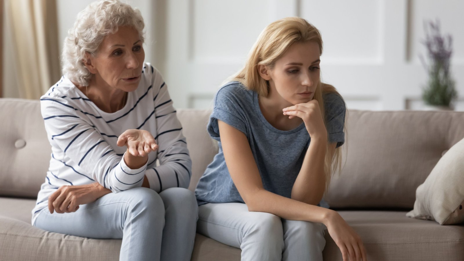 sad young mother daughter grandkid parent in law sitting on sofa fight fizkes shutterstock